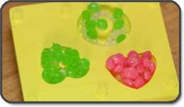 Add your favorite candy sprinkle/pellet combination into the mold.