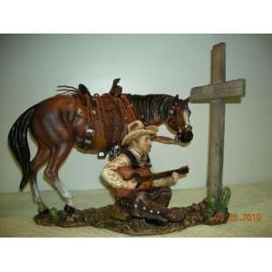  Cowboy Singing & Praying At A Cross Statue