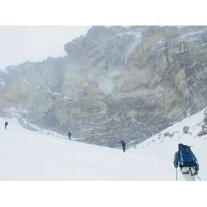  A Group of Back Country Skiers Climb Near Cliffs in 