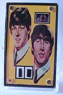 lennon and paul mccartney clothing swatch and film frame display