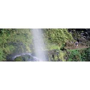 Hiker Taking Photographs of a Waterfall, Kapoloa Falls, Kohala, Hawaii 
